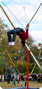 Student does a backflip at Homecoming Carnival.