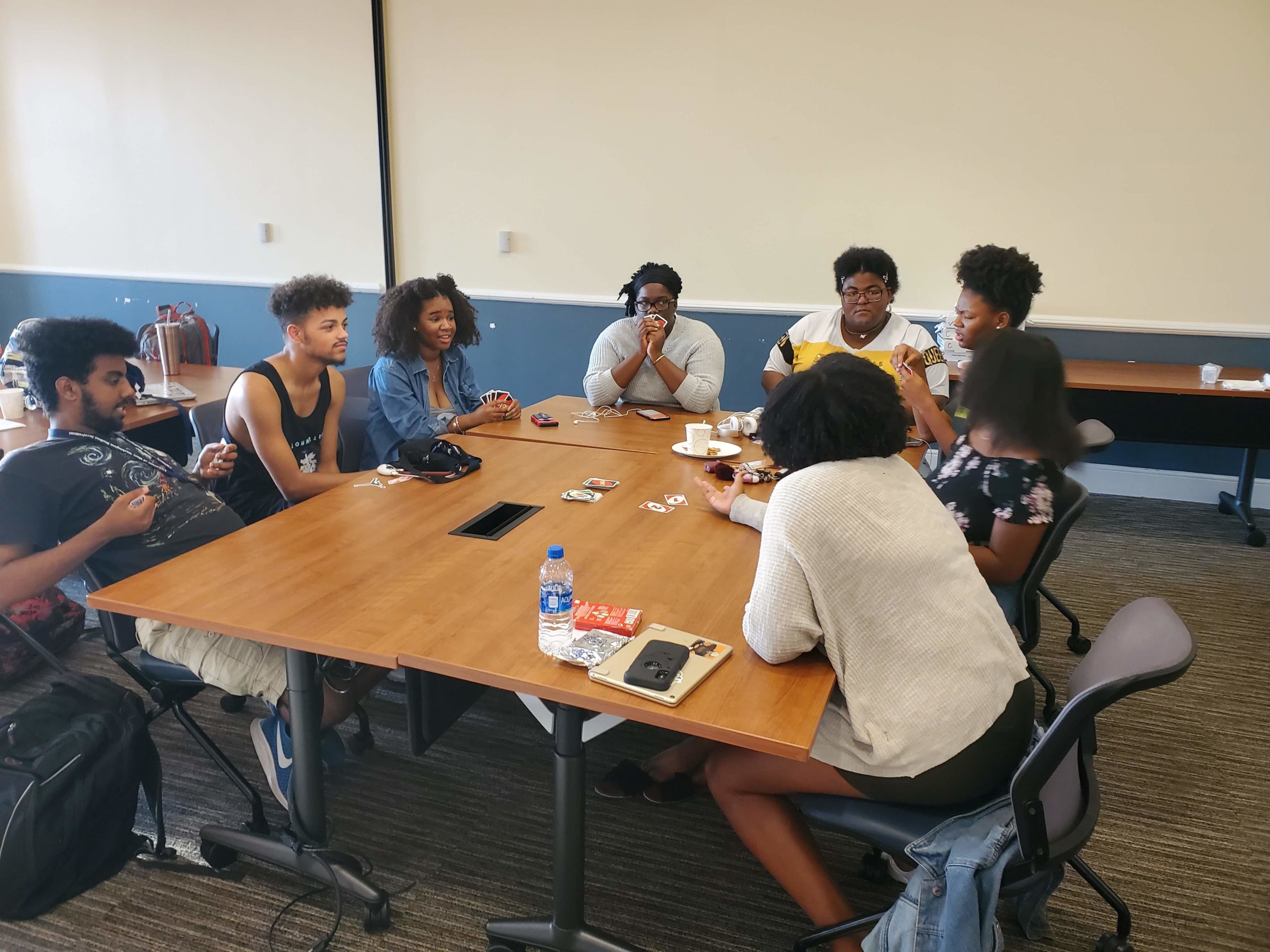 A group of students at a table playing UNO